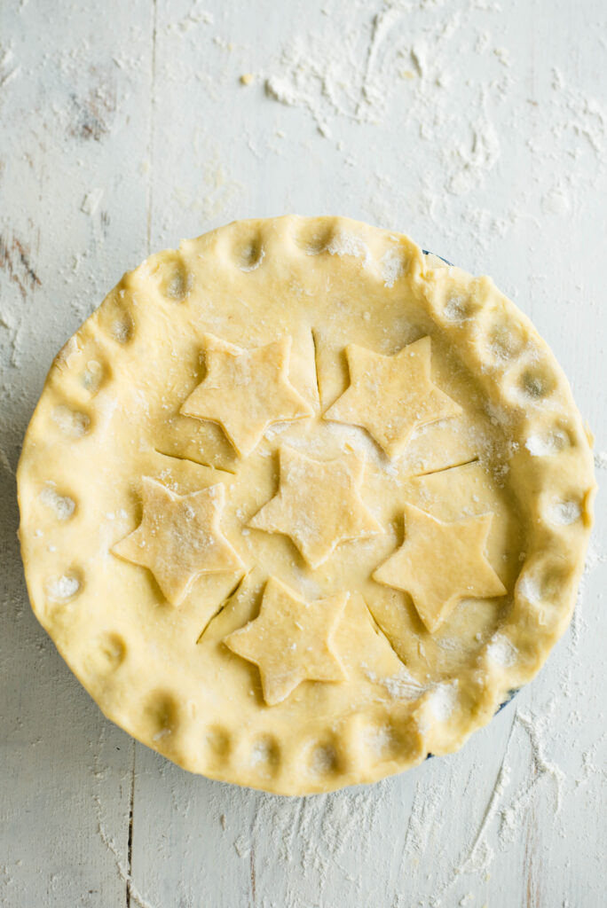 Mixed berry pie with honey assembled and ready for baking