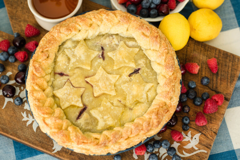 Homemade mixed berry pie with honey decorated with star shapes