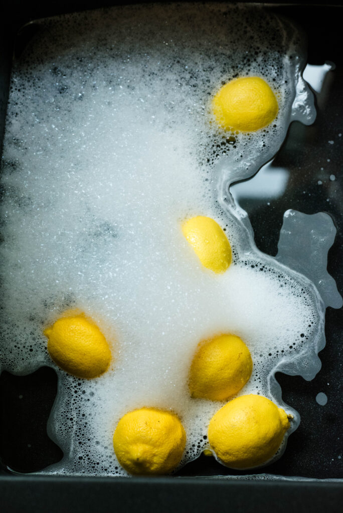Lemons soaking in soapy water.
