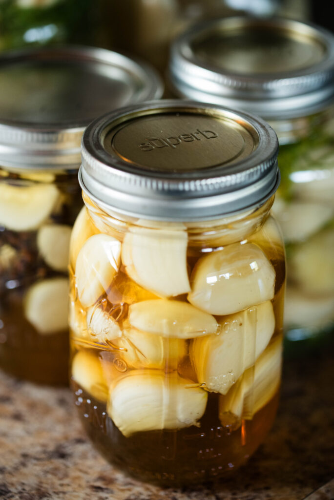 Jar of garlic resting on countertop.