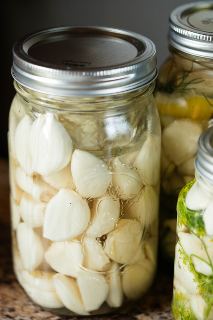 Jar of fermented garlic resting for fermentation.