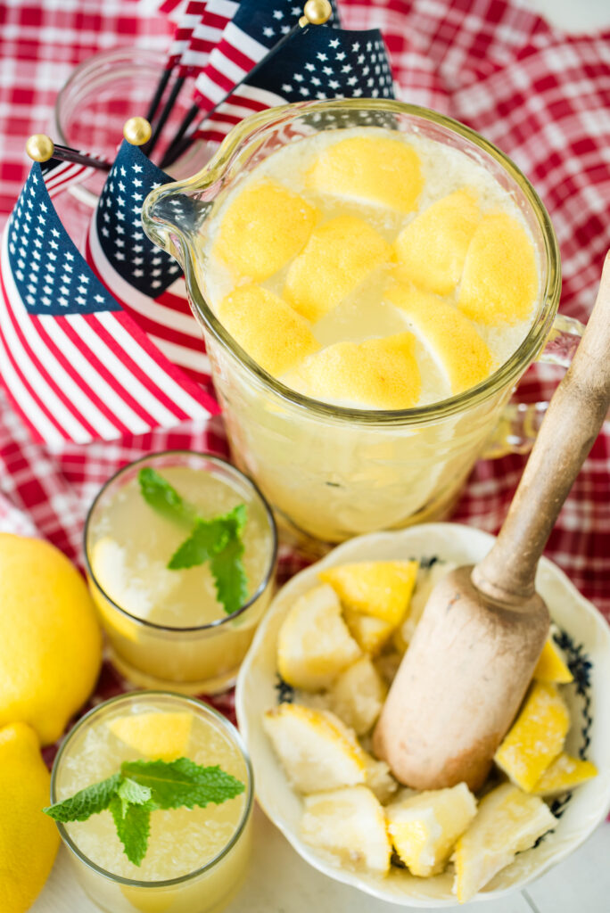 Pitcher of probiotic state fair lemonade and bowl of muddled sugar lemon wedges.