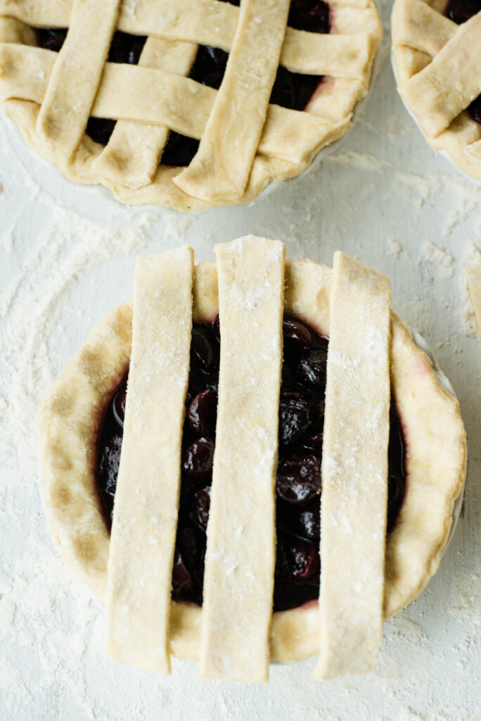 Cherry pie with three strips of dough for a lattice top.