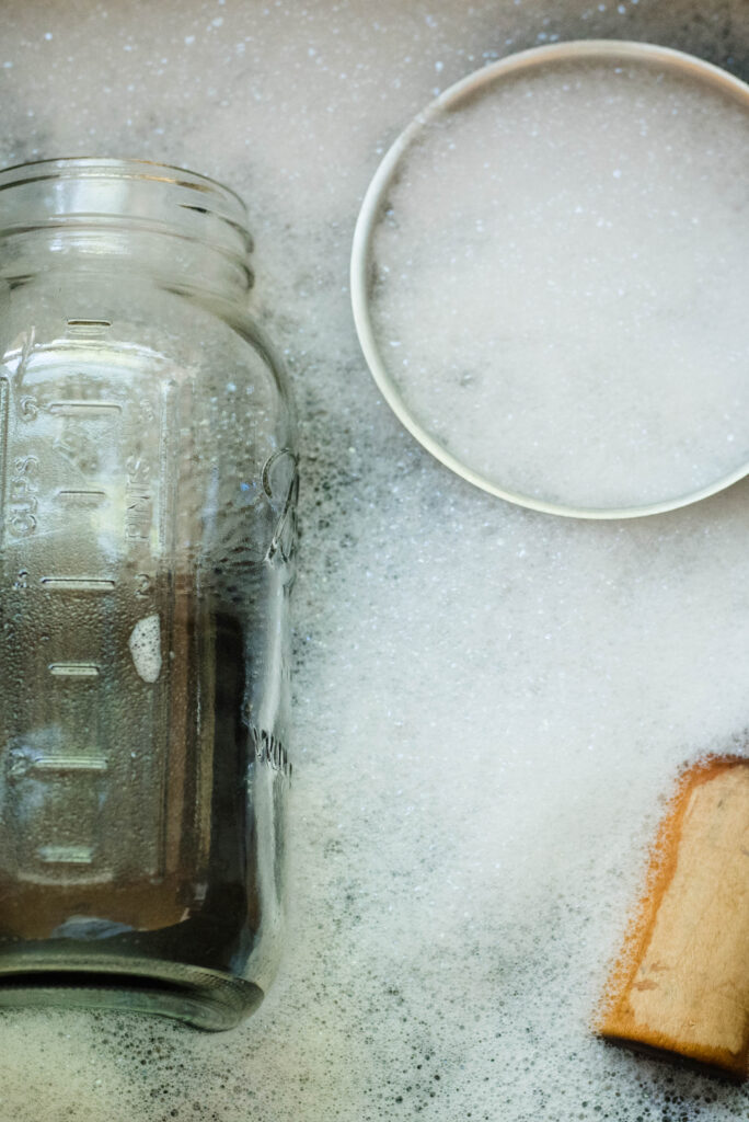 Dishes in soapy water to clean for fermentation.