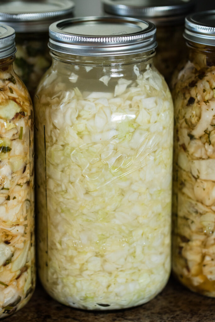 Jar of sauerkraut fermenting on the counter.