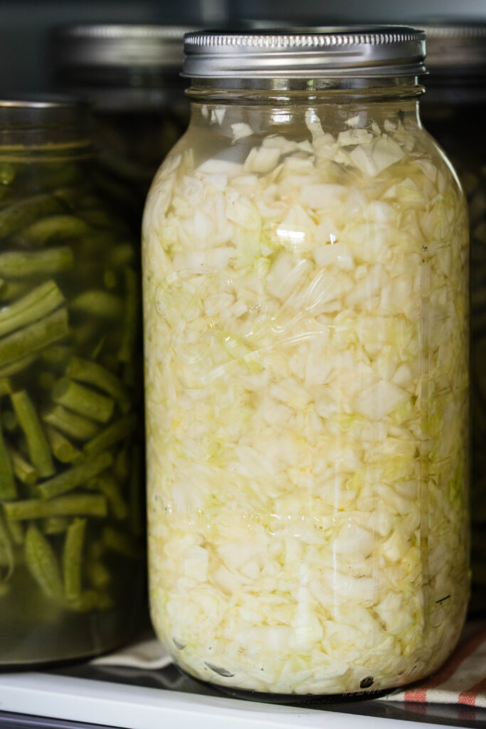 Jar of homemade sauerkraut stored in the refrigerator.