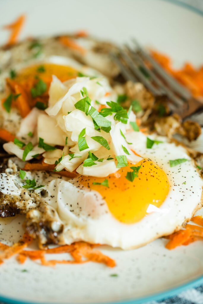 Fried eggs topped with sauerkraut.