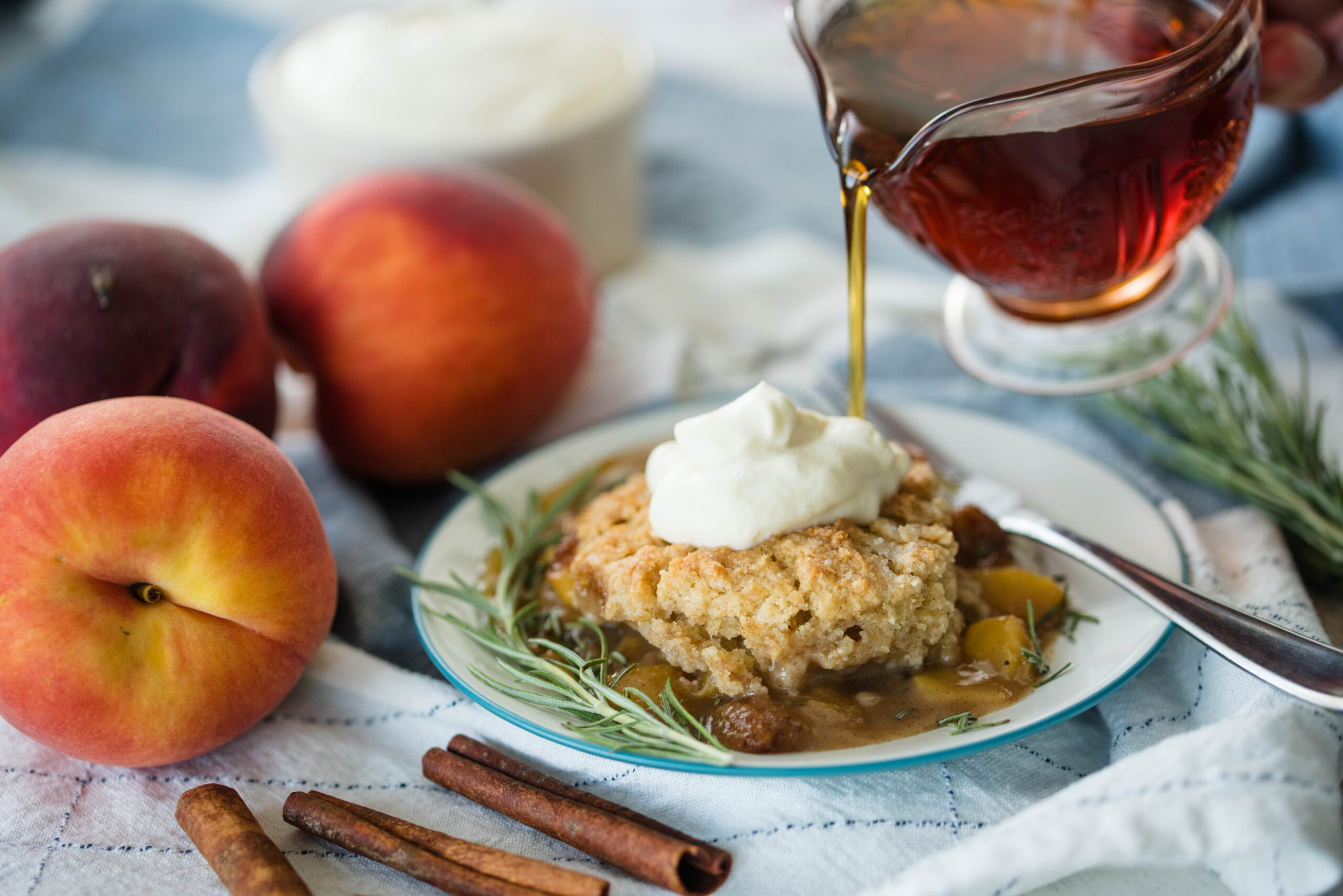 Old fashioned peach cobbler drizzled with maple syrup.