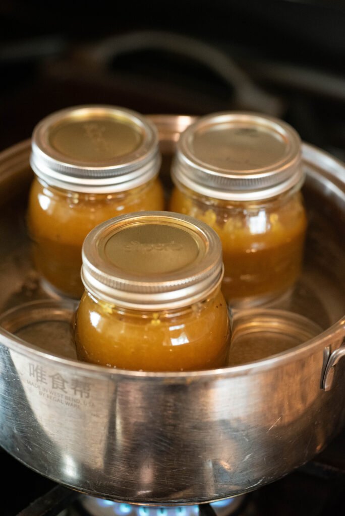 Jars of peach lavender jam being water bath canned.