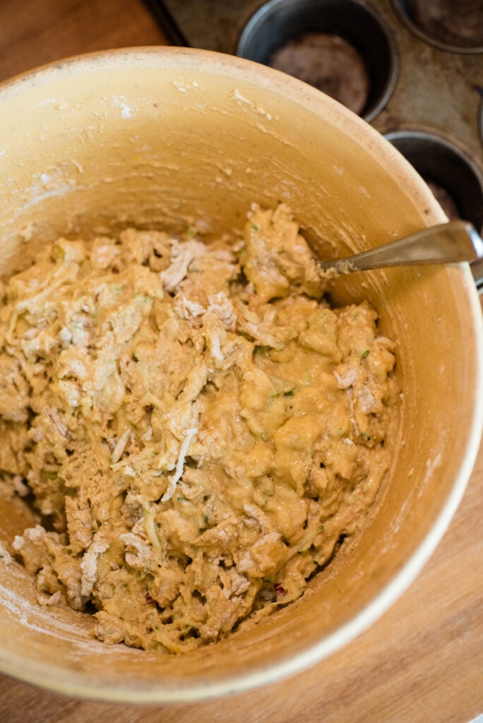 Apple spice muffins batter all mixed together in the bowl.