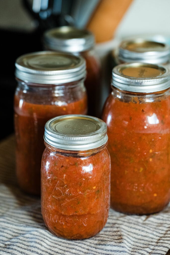 Jars of pasta sauce resting after canning.