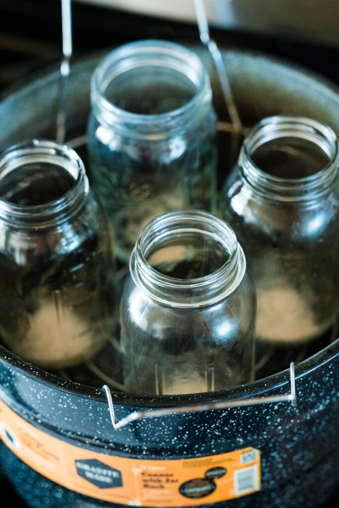 Empty jars warming up in a water bath canner.