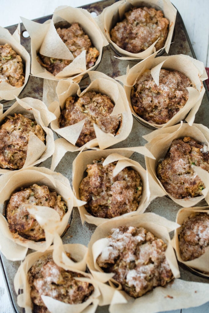 Tray of apple spice muffins with zucchini resting and cooling off.