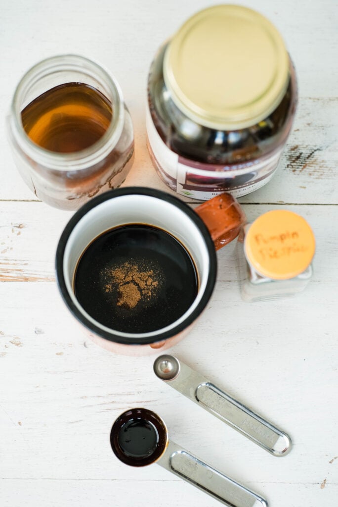 Molasses, vanilla and spice added to a mug for an herbal pumpkin spice latte.